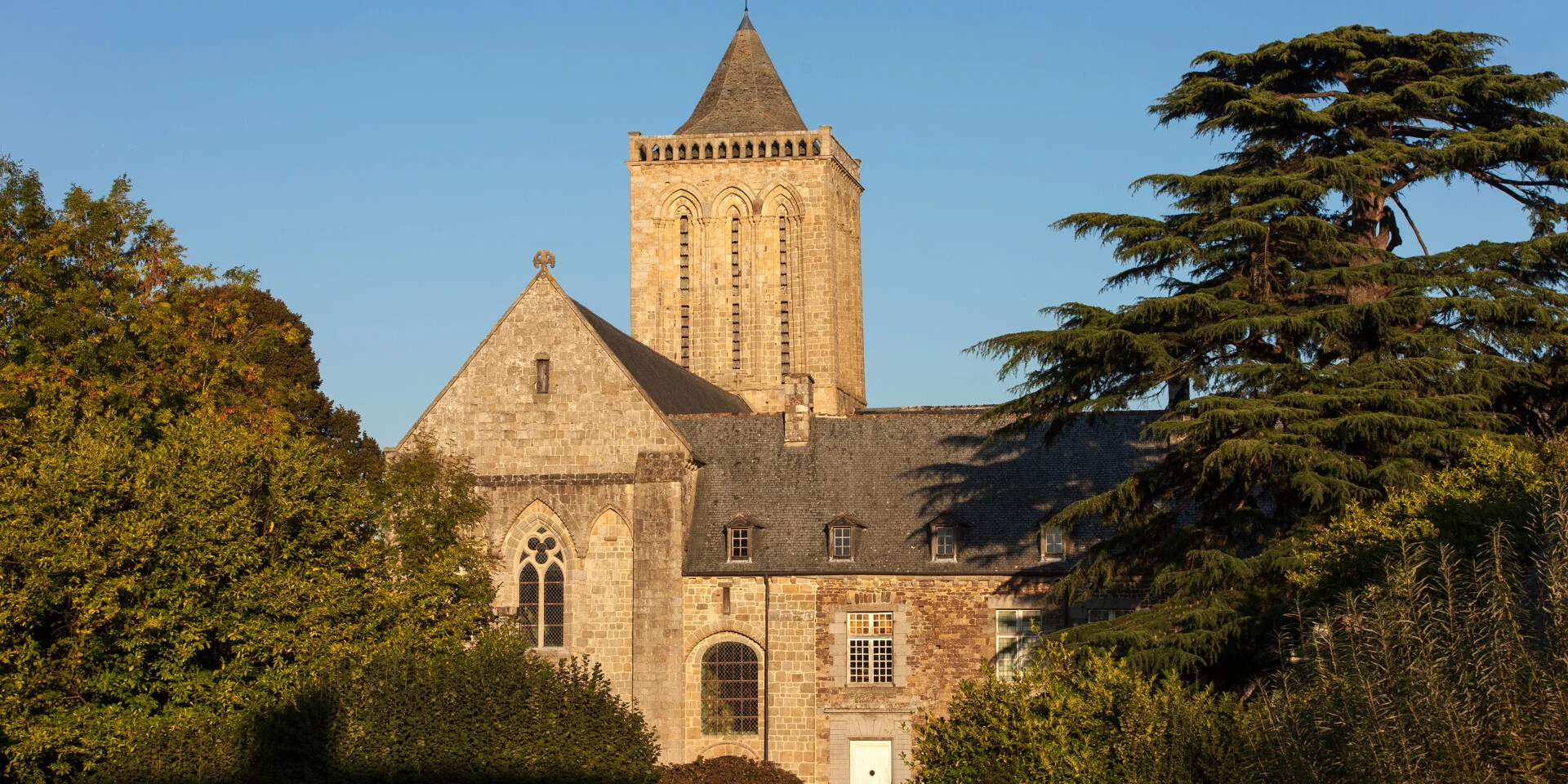 La Lucerne Abbey, 12th-century architecture in a green setting