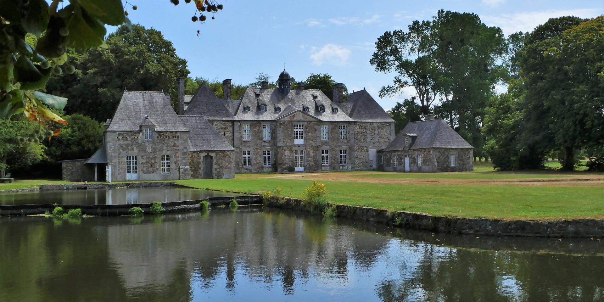 The Abbey of La Lucerne d'Outremer and its pond in the foreground