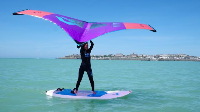 A young woman practices Wingfoil in Granville during a session for beginners