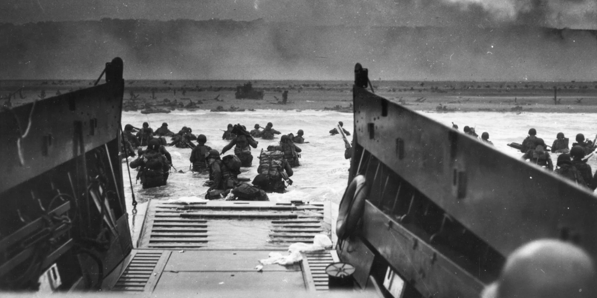 Army troops wade ashore on Omaha Beach during the D-Day landings, 6 June 1944. They were brought to the beach by a Coast Guard manned LCVP.  Photograph from the U.S. Coast Guard Collection in the U.S. National Archives.