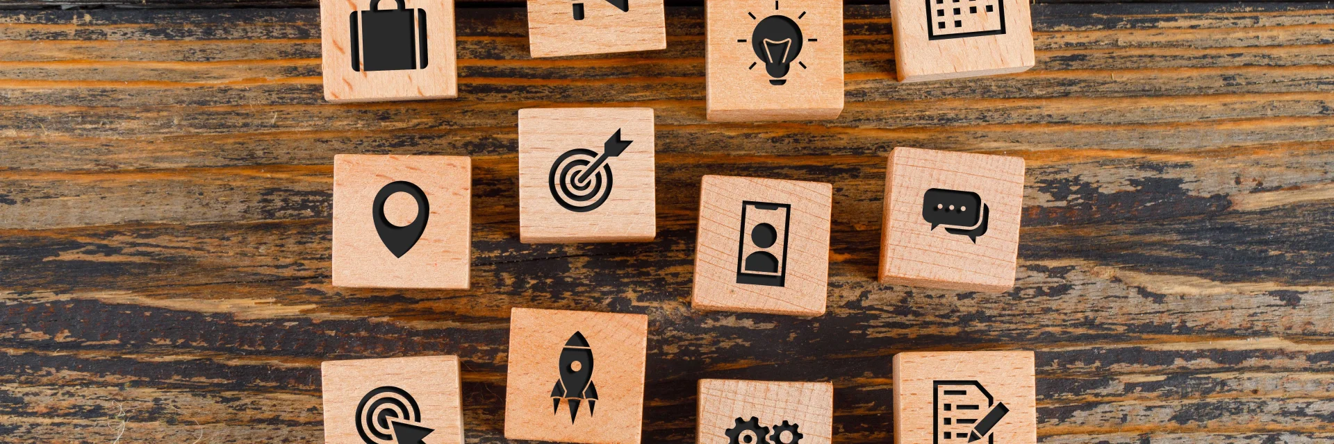 Business concept with icons on wooden cubes on wooden background flat lay.