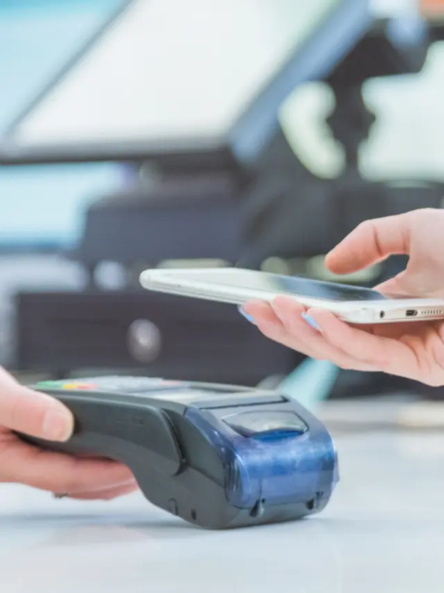 Close up of mobile payment in a shop.
