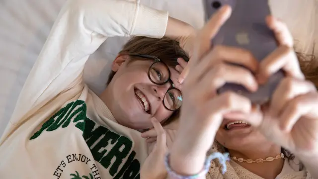 Children laughing on a bed