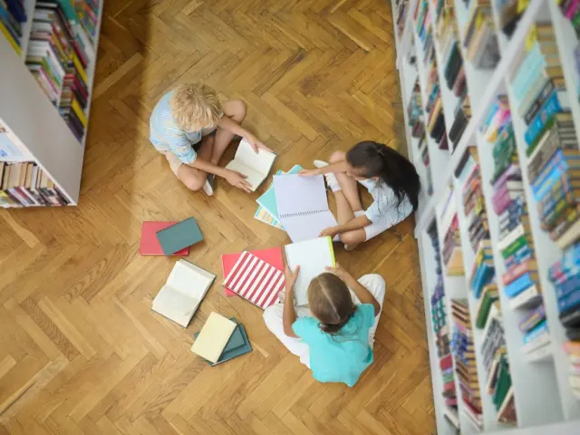 top-view-children-studying-floor-library.jpg