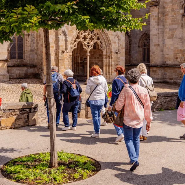 Un groupe de personne en visite guidée devant la Cathédrale de Tréguier