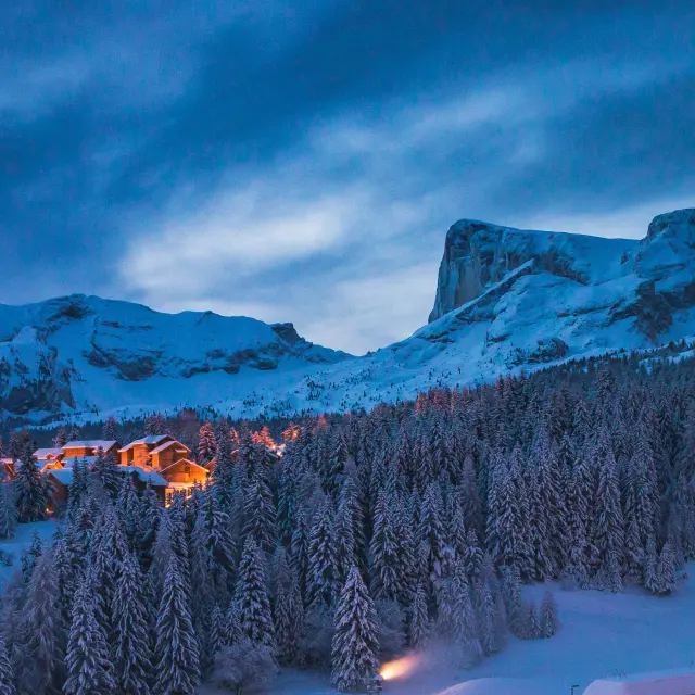 The ski resort of Superdévoluy at night under the snow with Pic de Bure in the background, in the Hautes-Alpes.