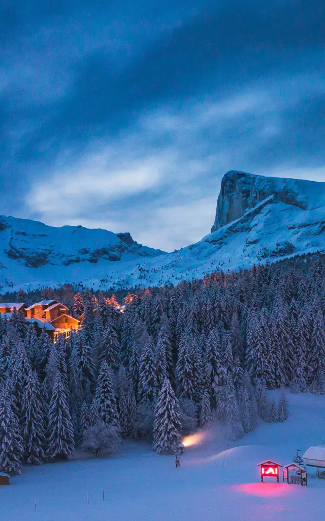 The ski resort of Superdévoluy at night under the snow with Pic de Bure in the background, in the Hautes-Alpes.