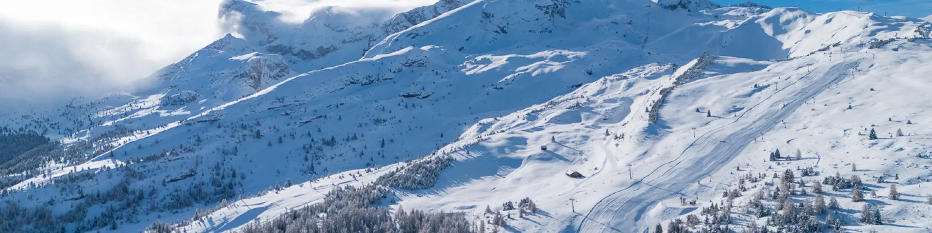 Aerial view of the snow-covered Le Dévoluy ski area, between forests and ski slopes.