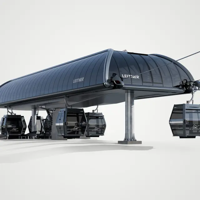 Scale model of the Jas gondola lift station in Superdévoluy with black glass cabins under a wide metal canopy.