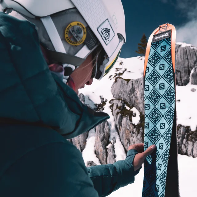 A skier puts her Salomon sealskins on her skis to set off on a hike