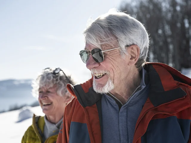 Des grands-parents et leur petit fils profitent d'une sortie raquettes