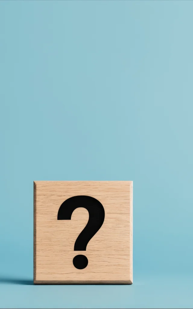 Question mark on wooden block against blue background