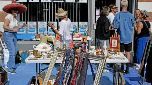 Stand at the Braderie de Lille with ties hanging in a frame, old crockery and a friendly atmosphere for bargain hunters.