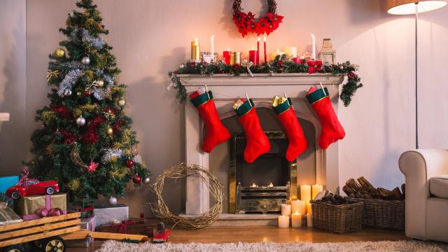 Christmas tree with presents near the fireplace at home in the living room