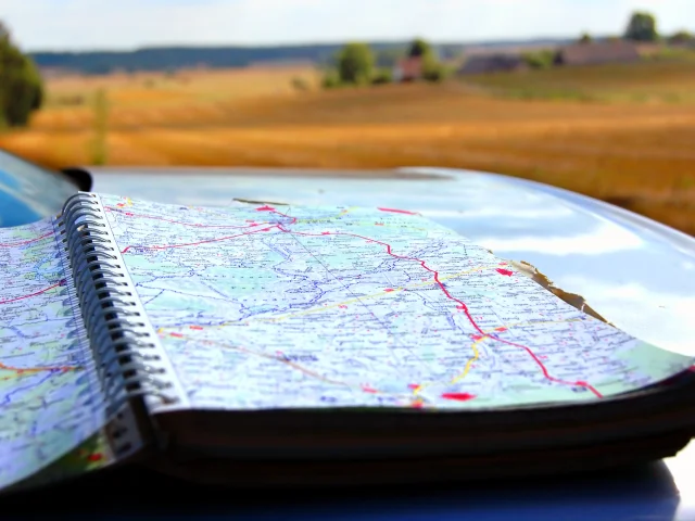 Map on car mask, on second plan summer holidays scenery