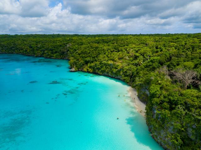 Aerial view of Kiki beach and the turquoise lagoon of Lifou, Loyalty Island, New Caledonia.