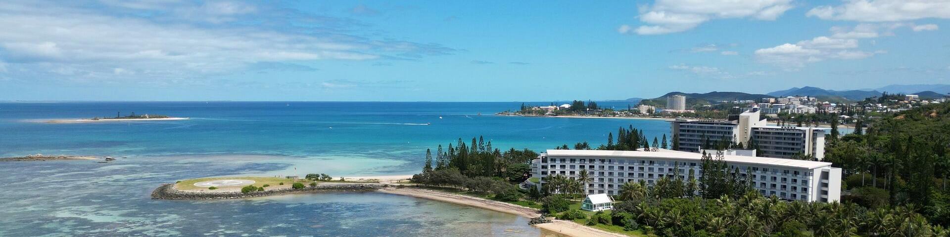 Aerial view of Pointe Magnin beach, Aquarêve beach, Le Méridien Nouméa and the Nouméa lagoon in New Caledonia.