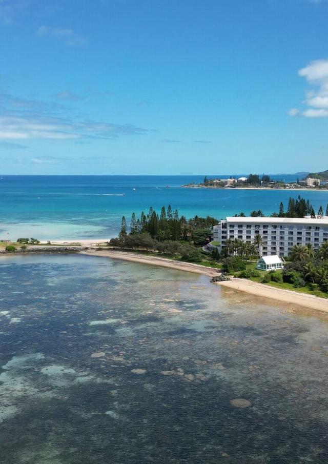 Aerial view of Pointe Magnin beach, Aquarêve beach, Le Méridien Nouméa and the Nouméa lagoon in New Caledonia.