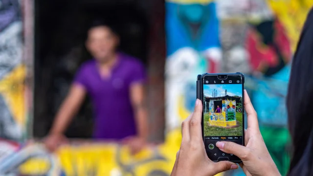 Couple taking a photo with street art in Thio, East Coast of New Caledonia
