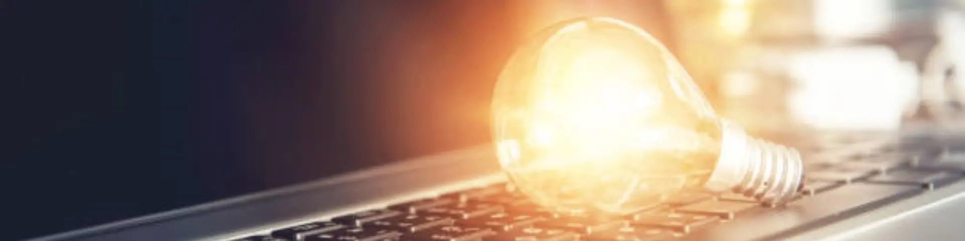 New ideas with innovation and creativity concept, Light bulb on keyboard laptop.