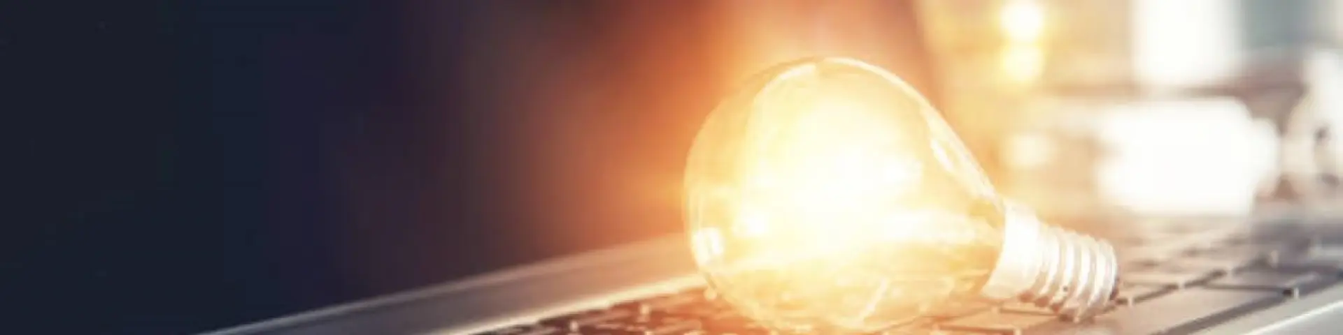 New ideas with innovation and creativity concept, Light bulb on keyboard laptop.