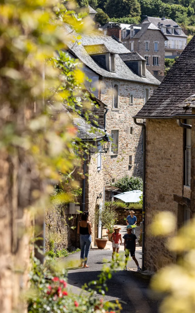 Une famille qui flâne dans les ruelles d'Aubazine