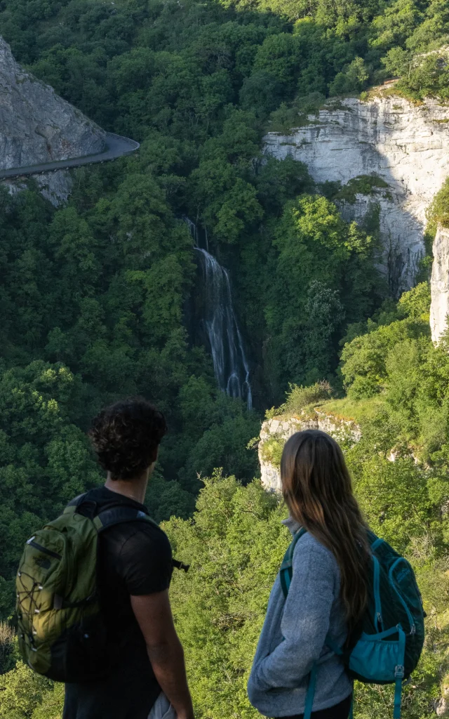 Deux randonneurs qui regardent au loin vers la cascade d'Autoire