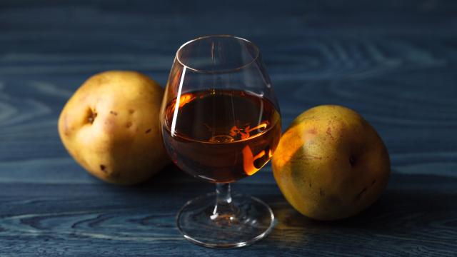 traditional fruit brandy and pears on a vintage grunge wooden background