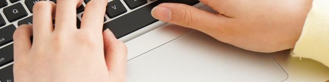 Young woman typing with laptop