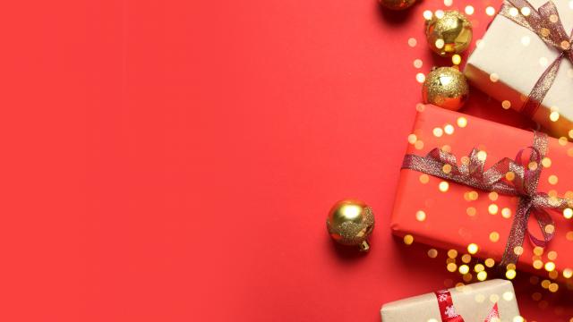 Christmas background with Gifts boxes, red ribbons, golden decorations on red background. Christmas, winter, new year concept. Flat lay, top view, copy space