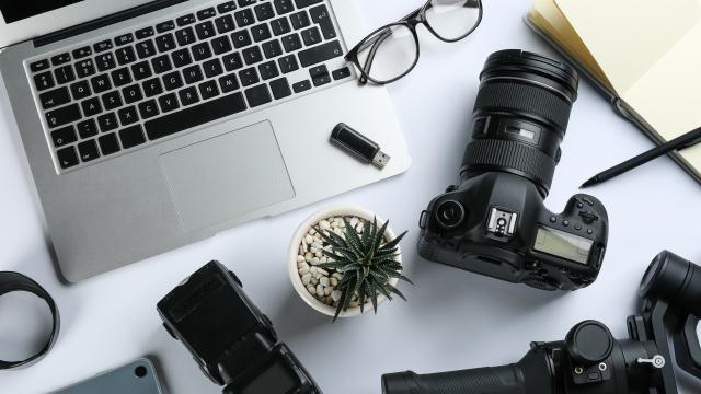 Composition with camera and video production equipment on white background, top view