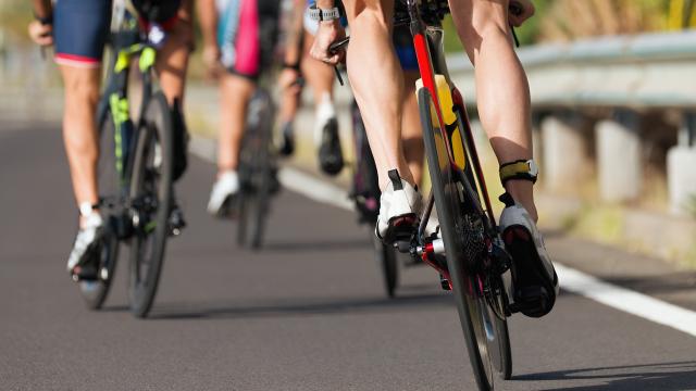 Cycling competition cyclist athletes riding a race at high speed