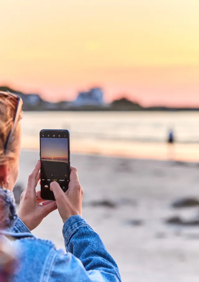 Photographing the sunset over the ocean