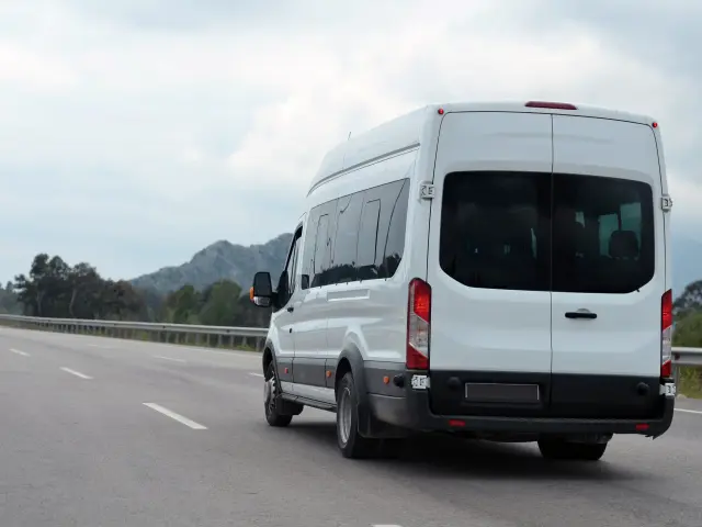 minibus in motion on a background of mountains