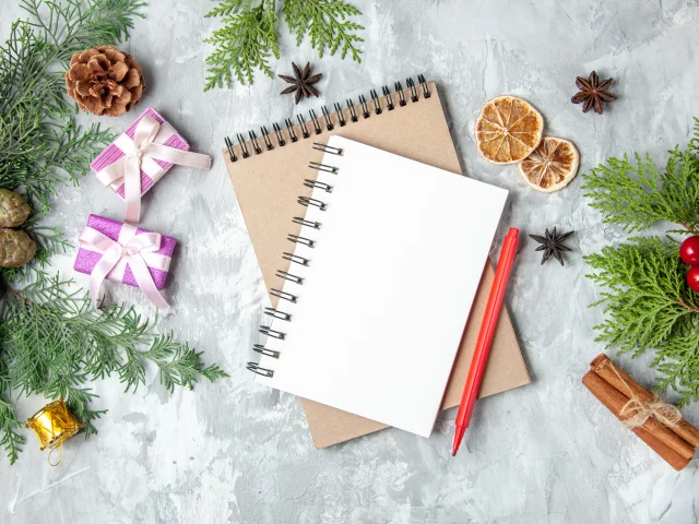 Top View Notebooks Xmas Gifts Pine Tree Branches Cinnamon Sticks Grey Surface