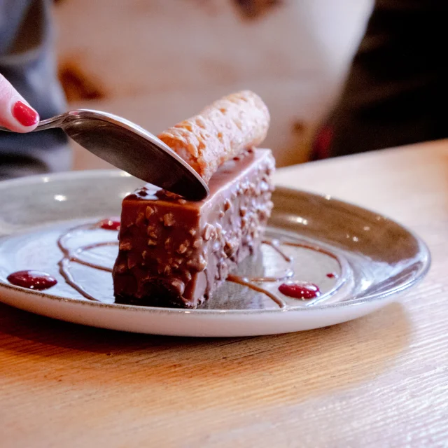 Un entremet au chocolat sur une assiette blanche