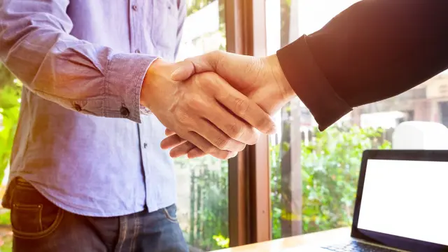 Two business men shaking hands.