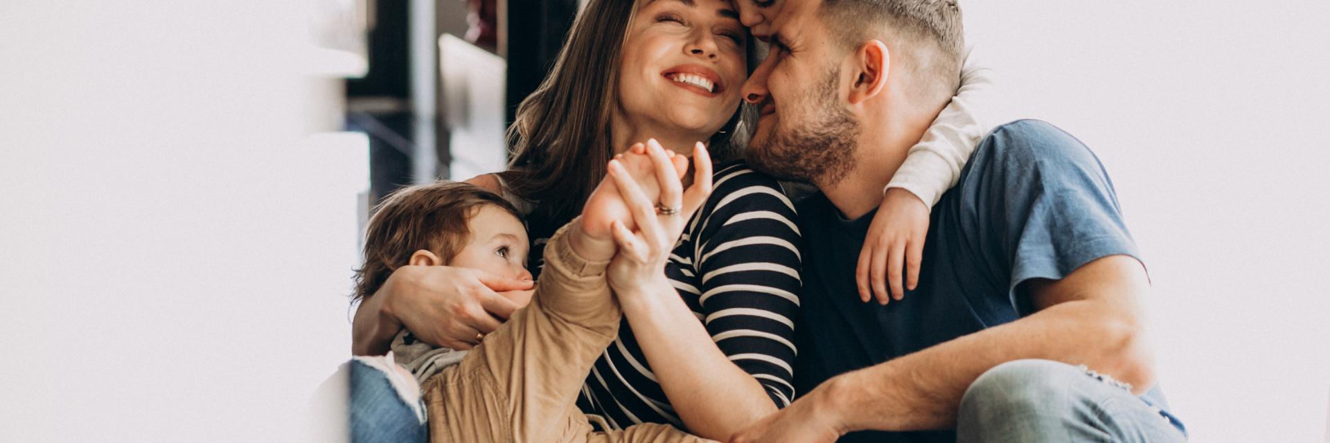 Young family with their sons at home having fun