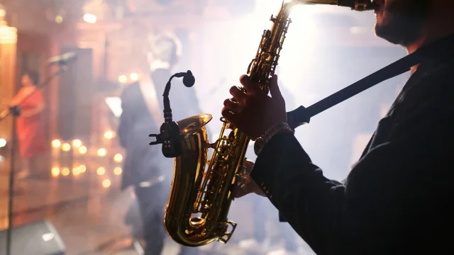 Man plays on a saxophone