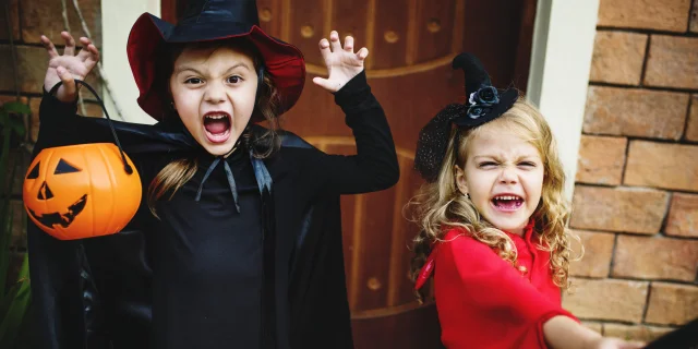 Little children trick or treating on Halloween