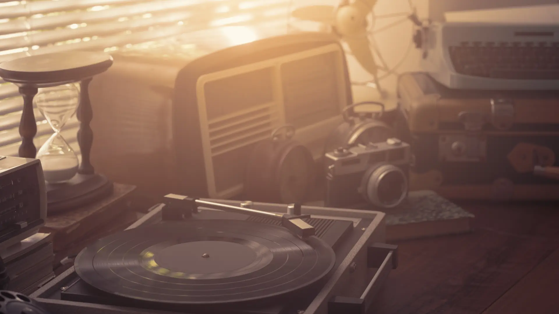 Vintage retro revival objects and appliances assortment on a table, turntable record player on the foreground