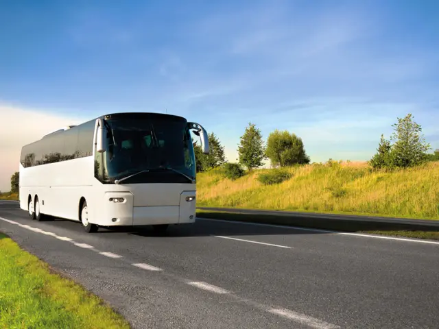 tour bus traveling down a major highway