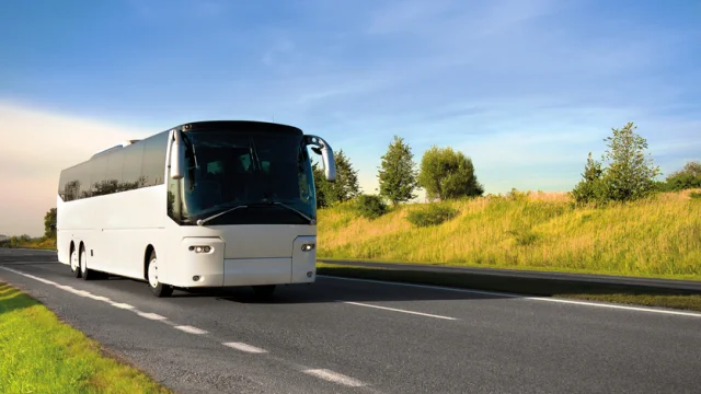 tour bus traveling down a major highway