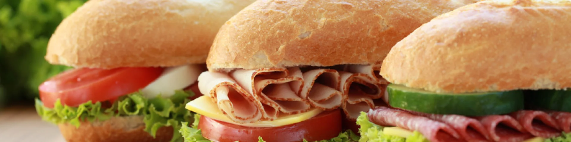 Drei Sandwiches sind belegt mit Schinken, Salami und Mozzarella