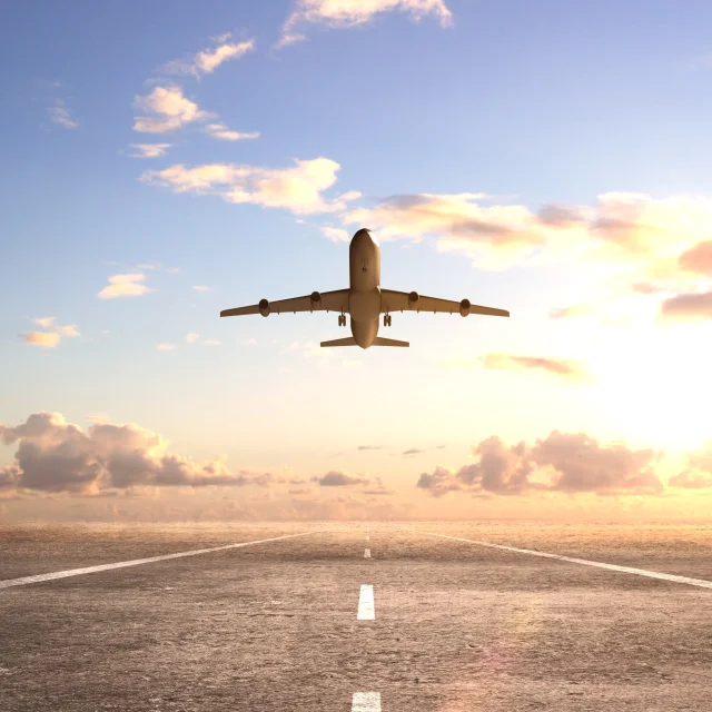 airplane on runway and looking at airplane in blue sky
