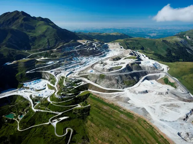 Aerial view of a mountain quarry with winding roads and construction areas