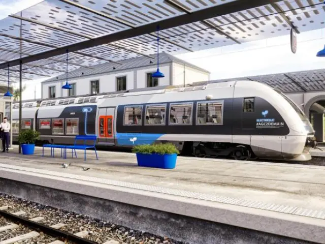 Modern train at the station with passengers waiting on the platform