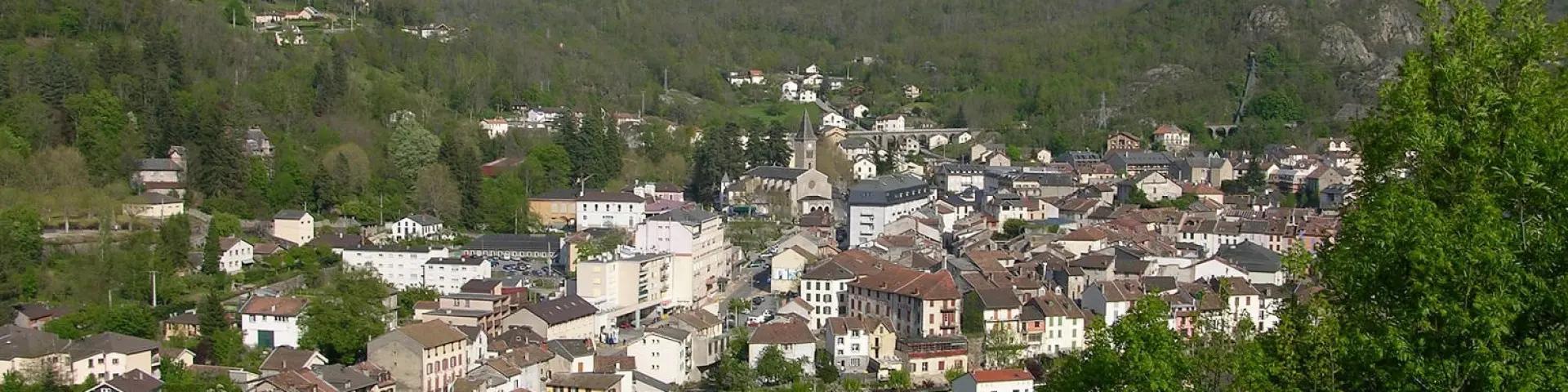 Village surrounded by mountains with houses and winding roads