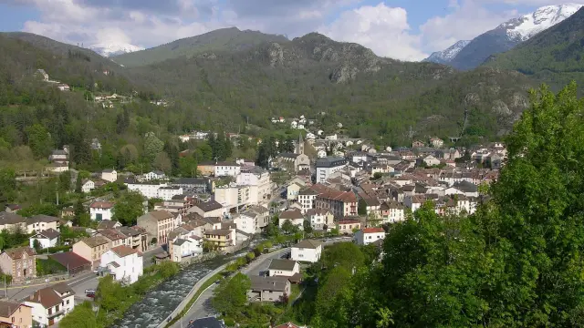 Village surrounded by mountains with houses and winding roads