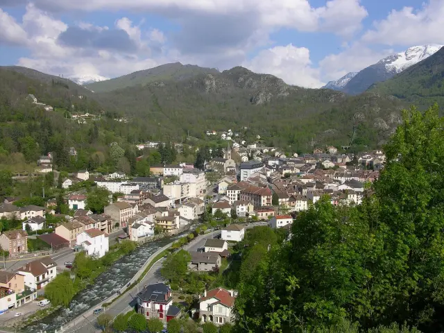 Village surrounded by mountains with houses and winding roads